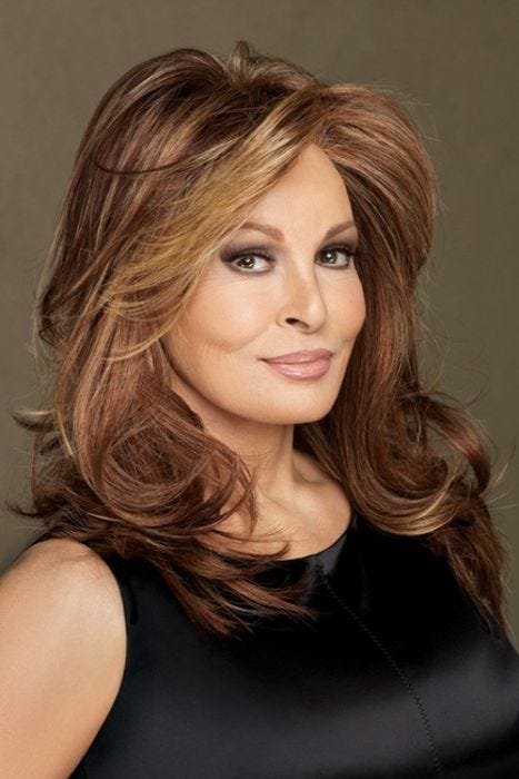 Raquel Welch in layered, past the shoulders medium auburn wig with lighter face framing layers