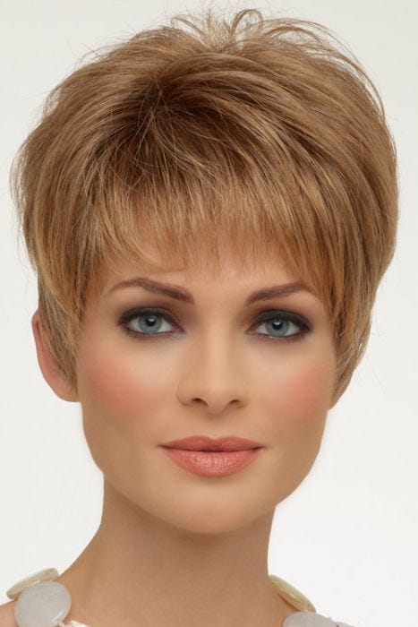 Woman in a classic blonde pixie wig with fringe bangs and longer layers on top