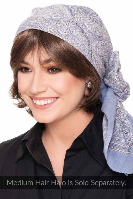 Woman in white and black paisley square cotton head scarf tied in bow for women with cancer