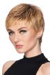 Woman in a reddish blonde textured pixie wig with short bangs