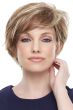 Woman in a long blonde and light brown pixie wig with side swept bangs