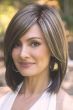 Woman in a shoulder length straight dark brown lace front wig with side bangs