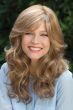 Woman in long curly blonde wig with bangs