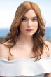 Woman in an extra long light auburn curly human hair wig