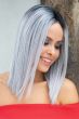 Woman in a straight past the shoulders silver blunt cut wig
