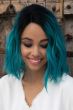 Black woman in a shoulder length teal wavy lace front wig