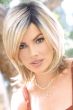 Woman in a shoulder length light blonde long layered bob wig
