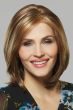 Woman in a shoulder length straight light auburn lace front wig