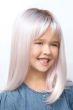 Young girl in a long children's wig in pastel pink with darker roots and wispy bangs
