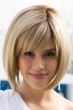 Woman in a chin length light blonde angled blunt bob wig with side fringe bangs