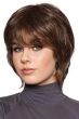 Woman in a shoulder length heavily layered dark brown bob wig with side bangs