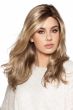 Woman in a past the shoulders wavy light brown lace front wig