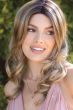 Woman in a 6" to 15" curly blonde lace front hair topper for thinning hair