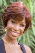 Afro American woman in a chin length red brown curly bob wig with side bangs