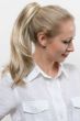 Woman in a 17" to 18" light blonde layered ponytail hair extension