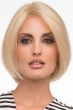 Woman in a chin length medium blonde curled-under straight bob wig