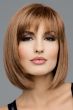 Woman in a shoulder length light brown bob wig with textured bangs