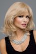 Woman in a shoulder length curly light golden blonde wig with textured bangs and long layers