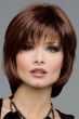 Woman in a short medium auburn bob wig with shaggy bangs and short face framing layers