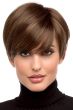 Woman in a long medium brown pixie wig with side swept bangs and shorter hair in back