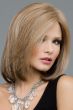 Woman in a dark blonde past the shoulders straight wig with a side part