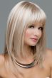 Woman in a long, past the shoulders platinum blonde wig with shoulder length layered and feathered bangs