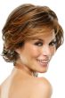 Woman in a cropped and layered, medium auburn, curly wig