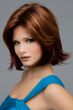 Woman in a medium auburn chin length flipped out bob wig with layering along the face