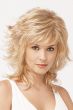 Woman in a shoulder length light blonde wig with feathered layers and choppy bangs