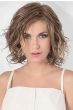 Woman in a shoulder length warm blonde lace front wig