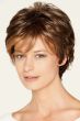 Woman in a medium auburn short wig with longer layers on the top and sides plus fringe bangs