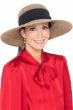 Woman in wide brimmed straw summer outdoor beach hat with black band