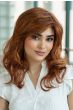 Woman in a past the shoulders curly dark blonde lace front wig with layers along the face