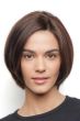 Woman in a human hair chin length dark brown rounded bob wig