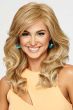 Woman in a large extra long curly warm blonde wig with side bangs