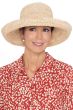 Woman in classic vacation or summer resort hat with upturned kettle brim - hand crocheted from straw for cancer patients.