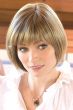 Woman in a chin length curled under blonde bob wig with textured bangs