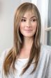 Woman in straight blonde long wig with bangs and light layers