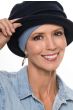 Woman in a black Fleece Leah Hat with a denim comfort headband underneath
