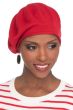 Woman in red knitted cotton beret hat for cancer patients