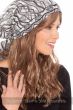 Woman in a long curly dark blonde halo hair piece with bangs under a white and black head scarf