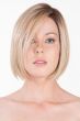 Woman in a chin length light blonde bob wig with dark roots