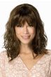 Woman in a past the shoulders wavy medium brown wig with fringe bangs
