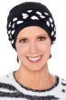 Woman in black cancer turban with black and white braided headband worn around it