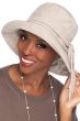 Woman in oatmeal big brimmed cotton UPF hat with adjustable tie for cancer patients