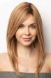 Woman in an extra long light auburn human hair wig with long layers