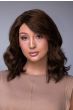Woman in a petite shoulder length dark brown curly human hair wig