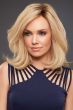 Woman in a petite shoulder length semi-wavy light ash blonde wig with long layers and dark roots