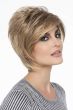 Woman in a layered dark blonde shaggy bob with side bangs