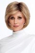 Woman in a long layered light brown pixie wig with side bangs